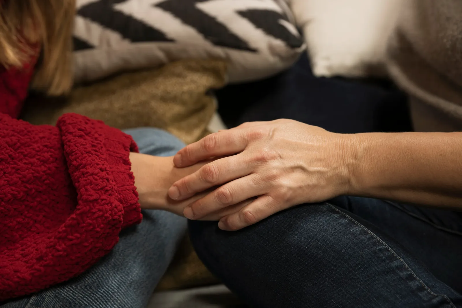 close up mother daughter holding hands 1 scaled 1