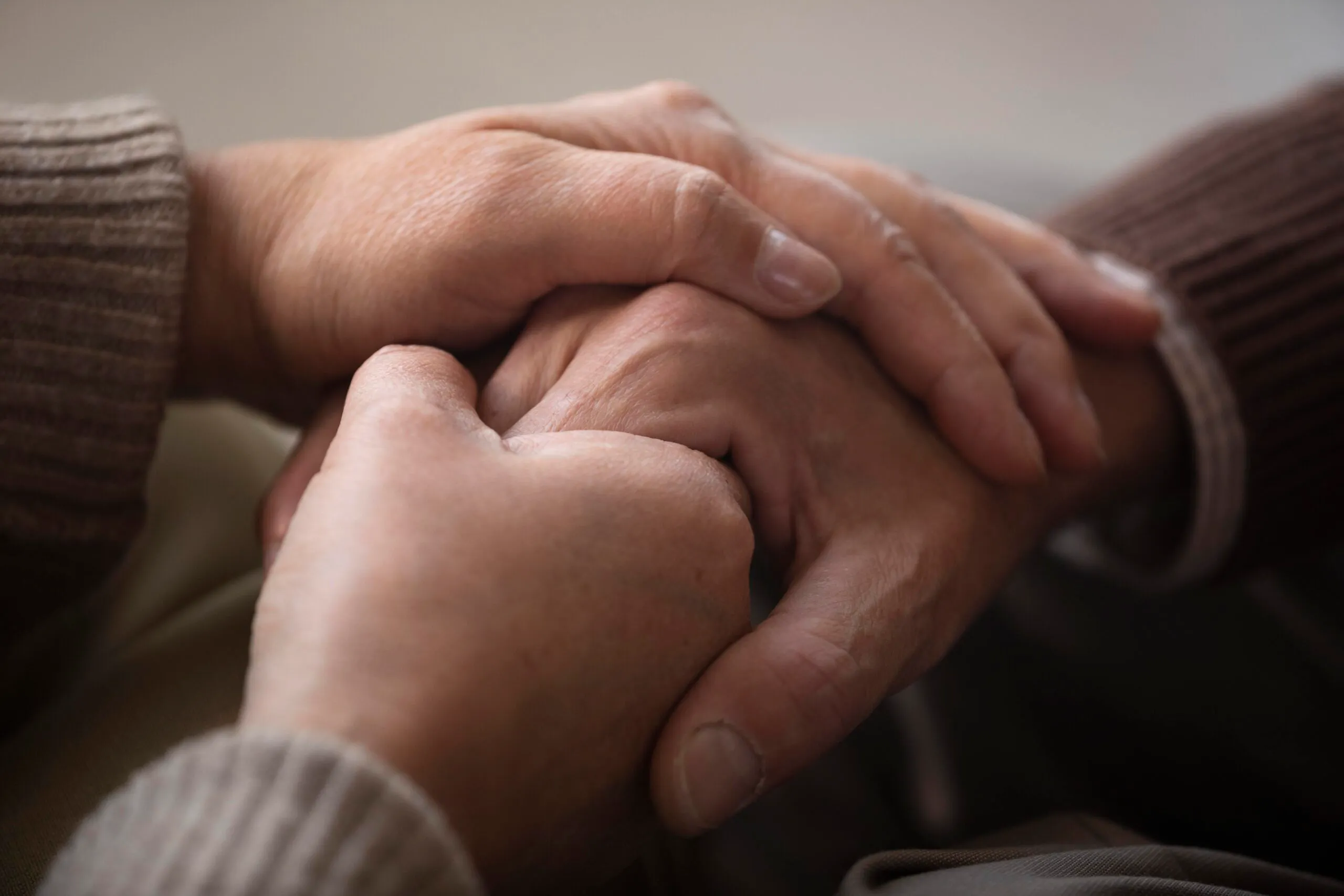 close up senior couple holding hands 1 scaled 1