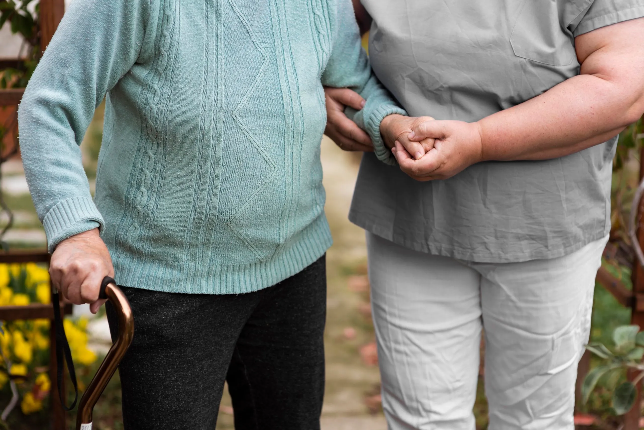 front view female nurse helping senior woman walk 1 scaled 1