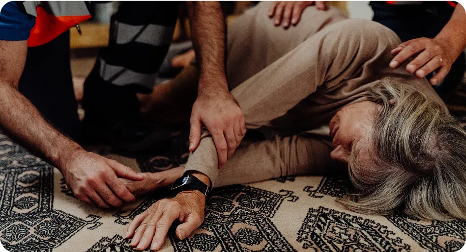 Person helping elderly person on the floor