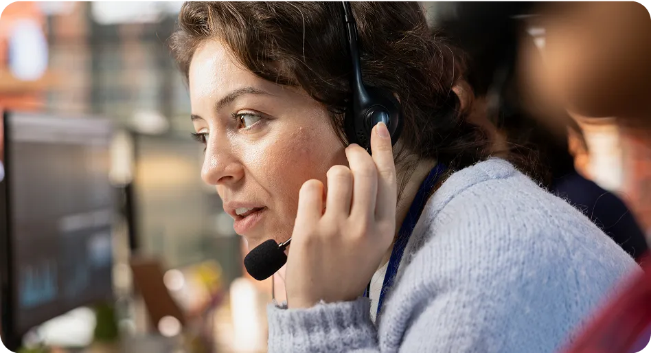 Woman with headset helping customer in call center
